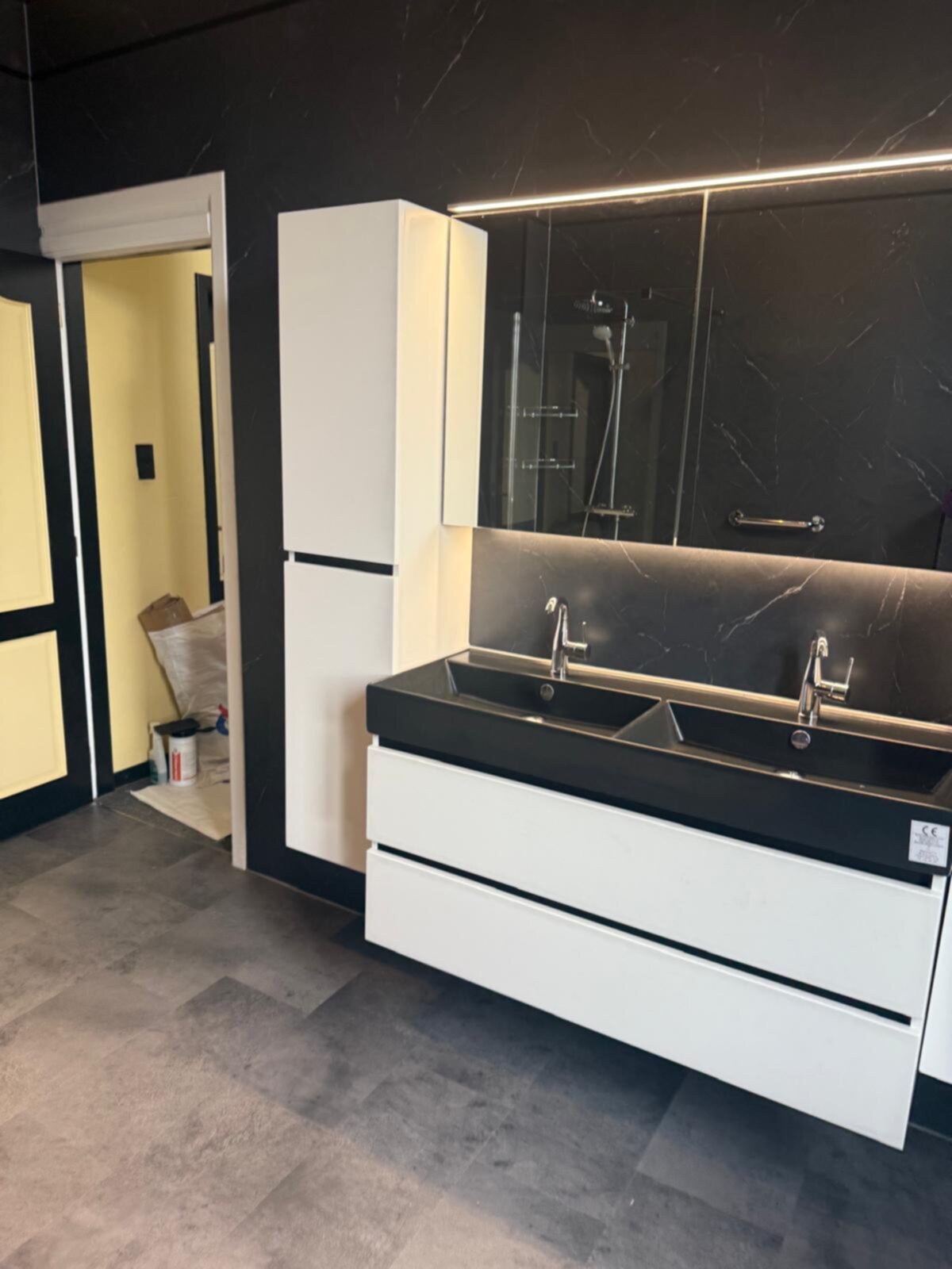 Moderne badkamer met zwarte en witte kleuren, dubbele wastafel en grote spiegel