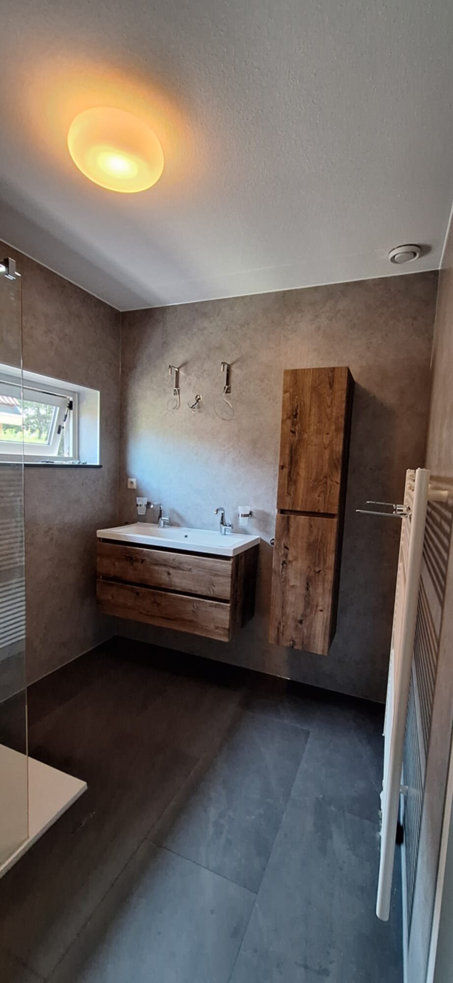 Moderne badkamer met houten meubelen en grijze tegels