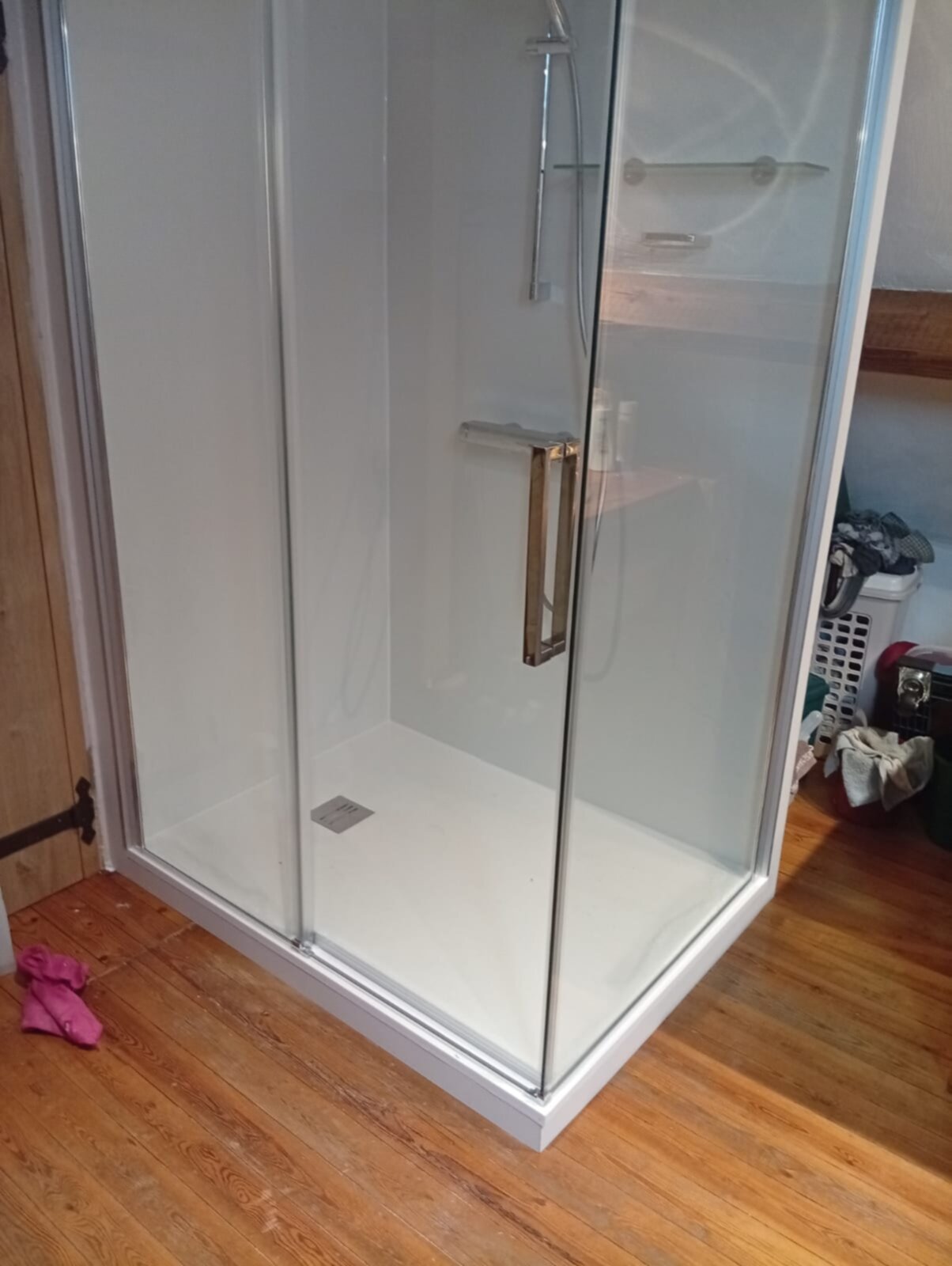 Douchecabine met glazen deur en witte betegeling