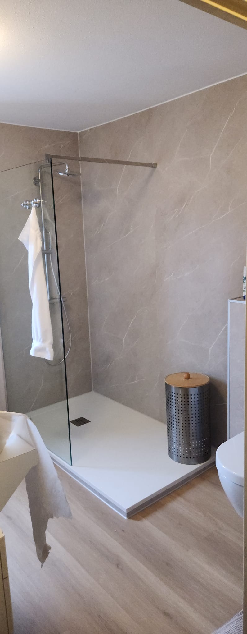 Moderne badkamer met inloopdouche, marmerlook wandpanelen en houtlook vloer